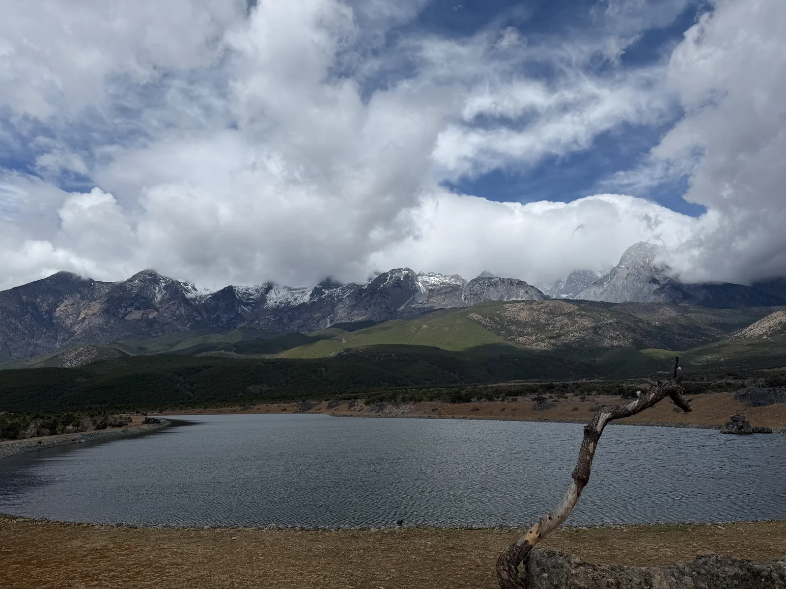 The Jade Dragon range under cloud, seen across a small lake