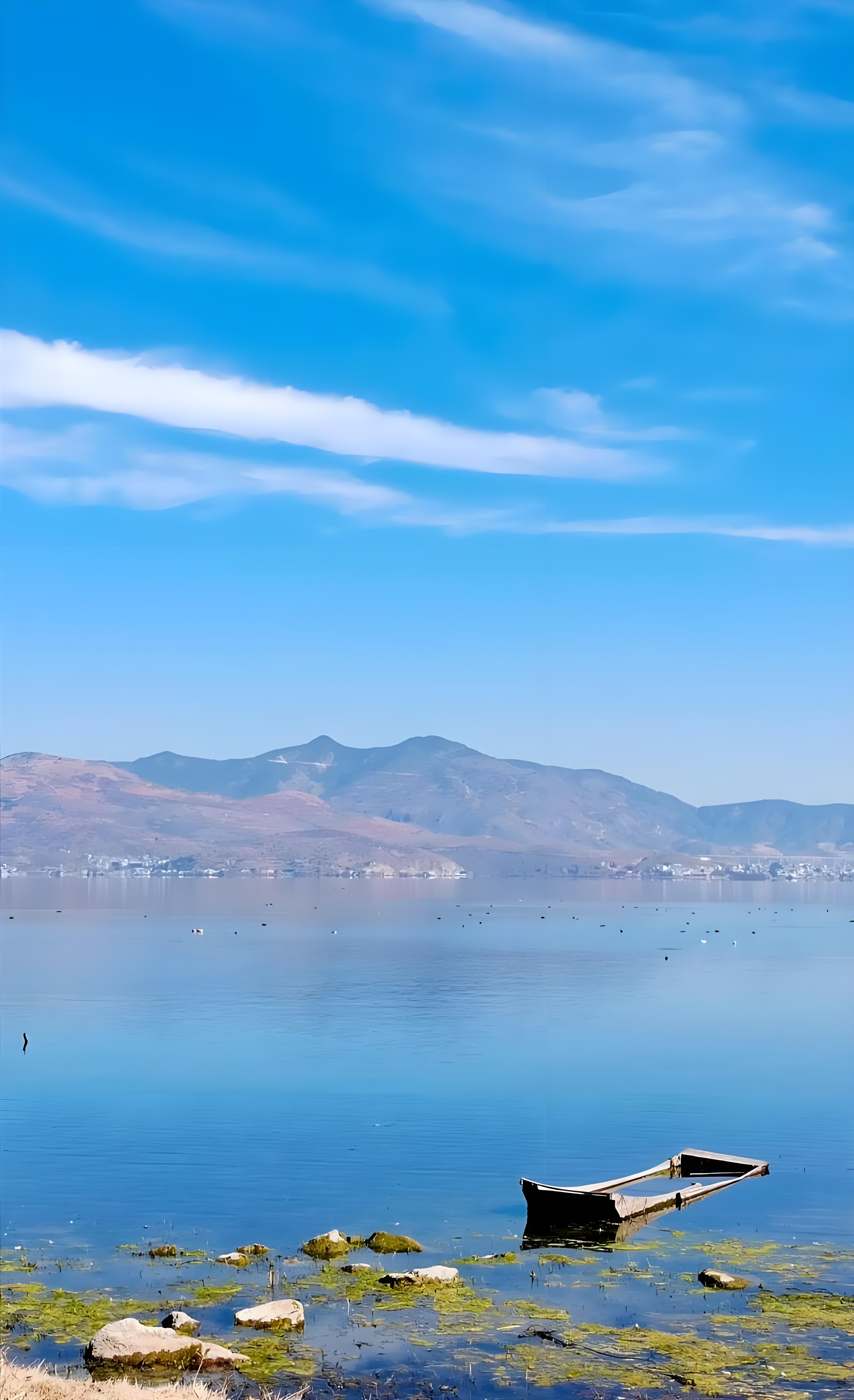 Erhai Lake beside Dali with a boat and mountain backdrop
